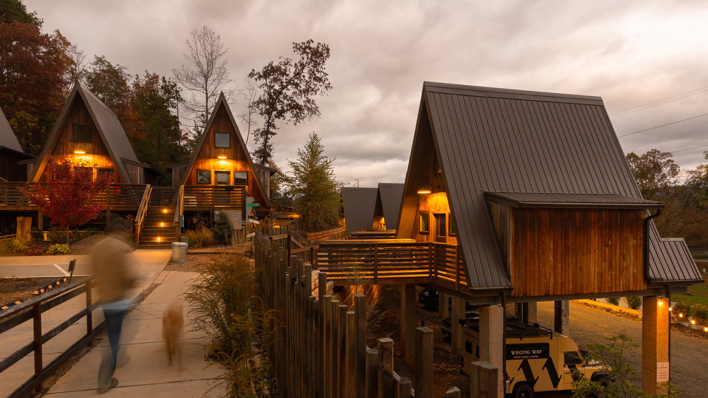 A-frame cabins glowing at dusk